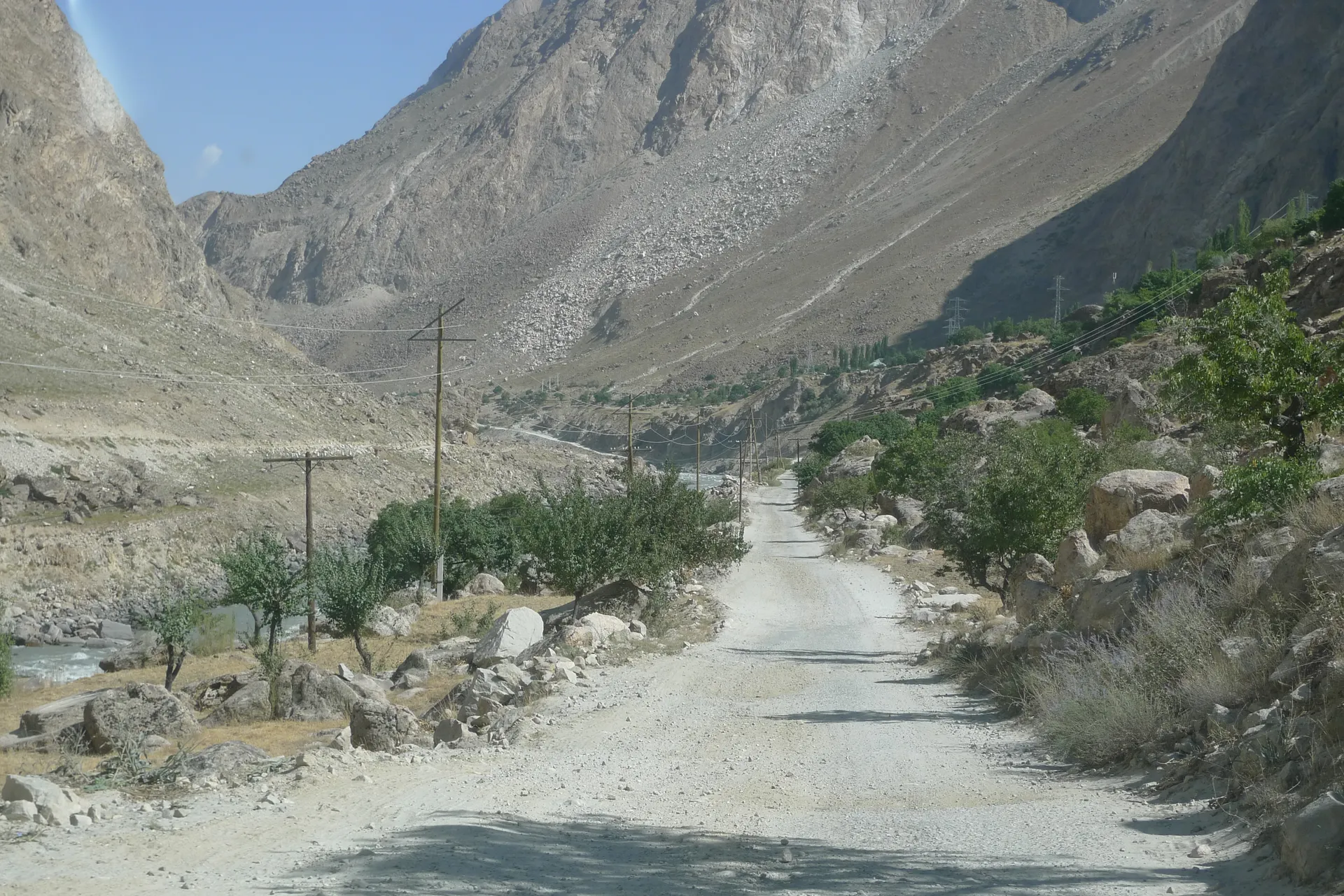 A dusty road leading up a dry mountain valley.