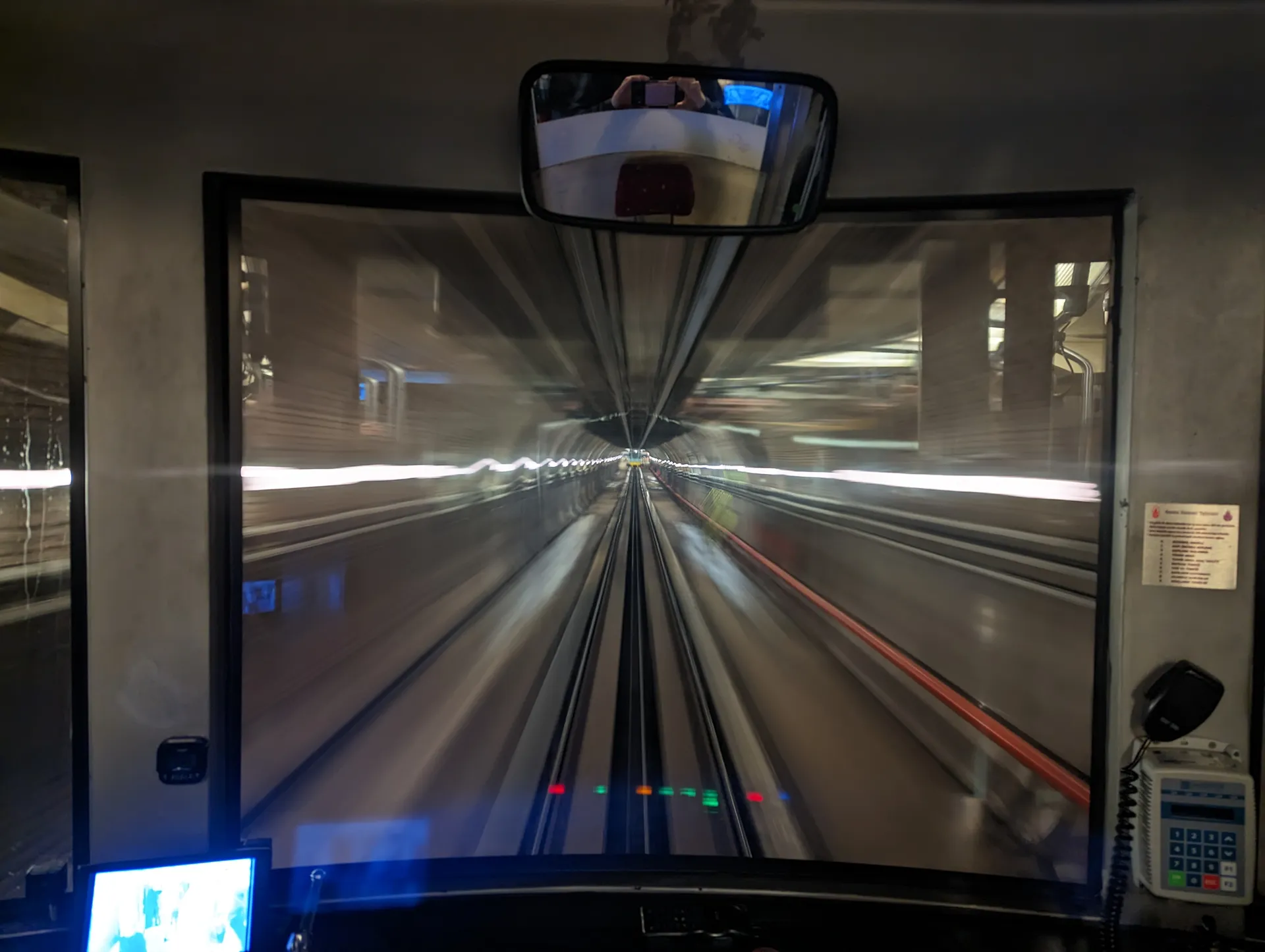 The view from the front of a metro train speeding through a tunnel.